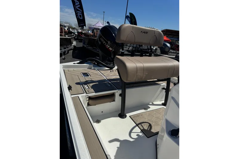 Slide: The Image of Avid 207 Recon 2026 boat interior with tan seating and deck, displayed outdoors. - 4