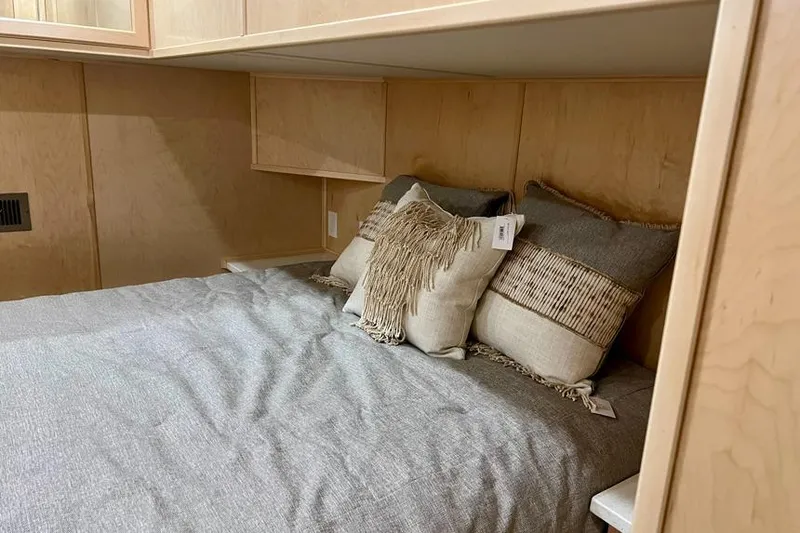 Slide: The Image of Cozy bedroom in 2026 Sumerset Luxe I houseboat with stylish pillows and wooden cabinetry. - 10