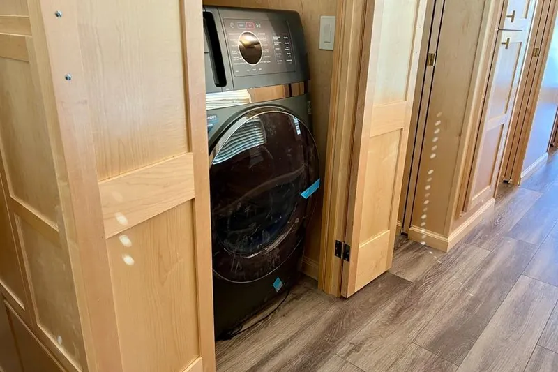 Slide: The Image of Modern laundry area with a sleek washing machine in a Sumerset Luxe I, 2026 model. - 11