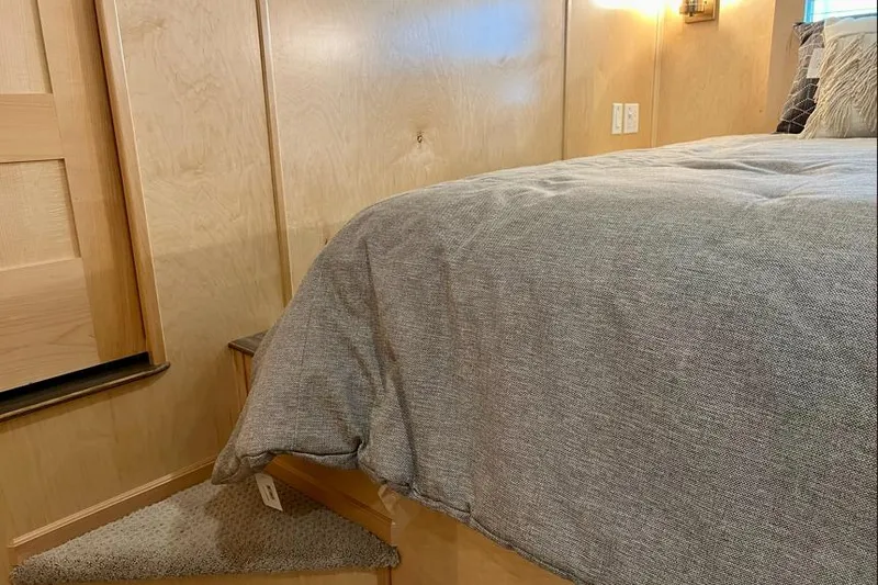 Slide: The Image of Cozy bedroom interior in 2026 Sumerset Luxe I houseboat, featuring wooden paneling and a plush bed. - 5