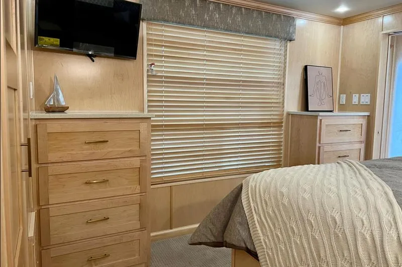 Slide: The Image of Luxurious Sumerset Luxe I 2026 bedroom interior with wooden drawers, TV, and cozy bedding. - 7