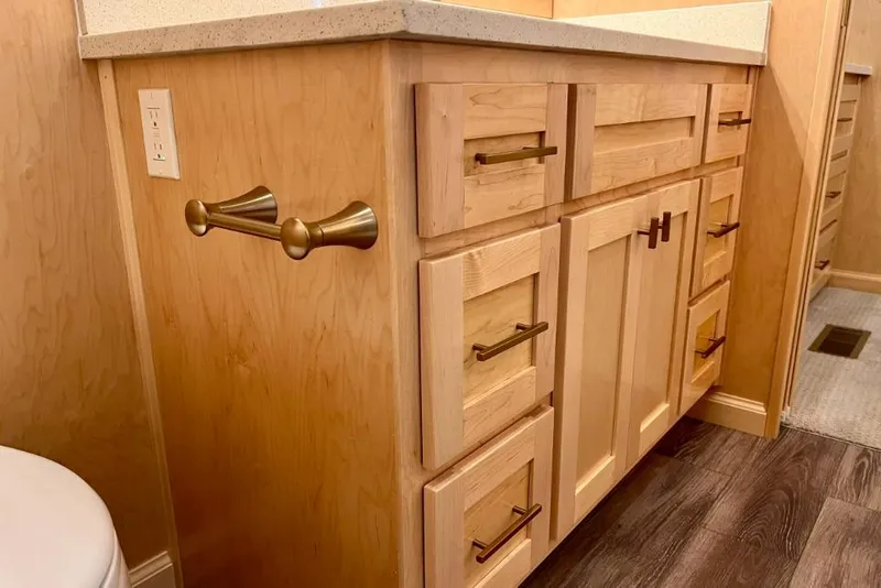 Slide: The Image of Wooden cabinetry with brass handles in a Sumerset Luxe I, 2026 model. - 8