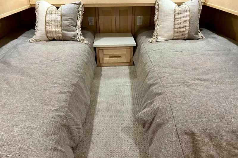 Slide: The Image of Twin beds with neutral bedding in a 2026 Sumerset Luxe I houseboat. - 9