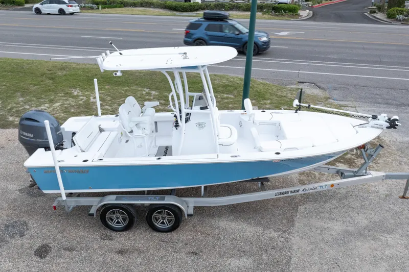 Slide: The Image of 2023 Sportsman Masters 227 Bay Boat on trailer, parked near a road. - 10