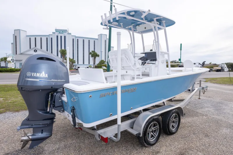 Slide: The Image of 2023 Sportsman Masters 227 Bay Boat with Yamaha engine on trailer, parked outdoors. - 12