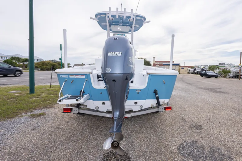 Slide: The Image of 2023 Sportsman Masters 227 Bay Boat with powerful outboard motor, parked on a trailer. - 14