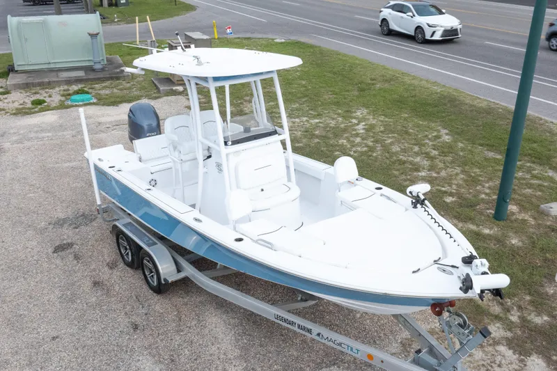 Slide: The Image of 2023 Sportsman Masters 227 Bay Boat on trailer, parked near road. - 17