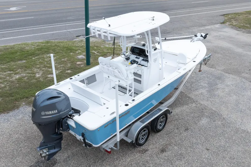 Slide: The Image of 2023 Sportsman Masters 227 Bay Boat with Yamaha engine on trailer, parked near road. - 18