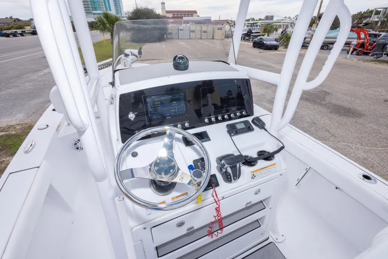 Slide: The Image of 2023 Sportsman Masters 227 Bay Boat dashboard with steering wheel and controls. - 20