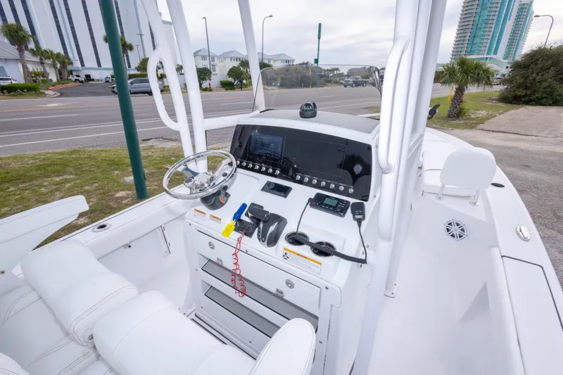 Slide: The Image of 2023 Sportsman Masters 227 Bay Boat cockpit with modern controls and steering wheel. - 22