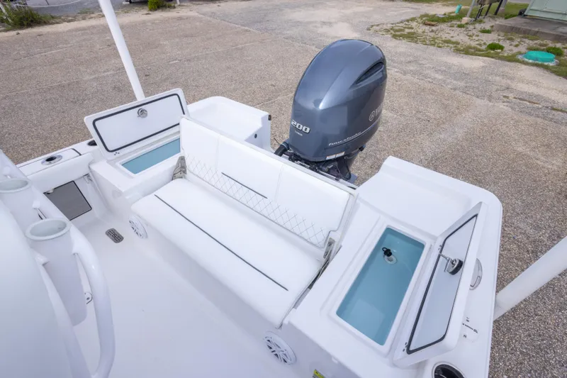 Slide: The Image of 2023 Sportsman Masters 227 Bay Boat with Yamaha engine, featuring spacious seating and storage compartments. - 25