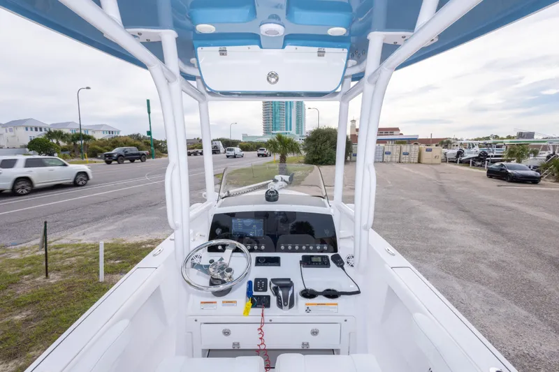 Slide: The Image of 2023 Sportsman Masters 227 Bay Boat dashboard with steering wheel and controls. - 32