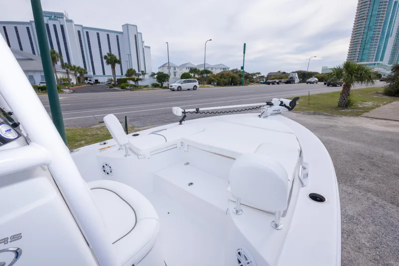 Slide: The Image of 2023 Sportsman Masters 227 Bay Boat parked near a road with buildings in the background. - 33