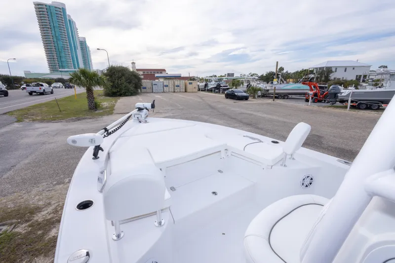 Slide: The Image of 2023 Sportsman Masters 227 Bay Boat parked near a road with buildings in the background. - 34