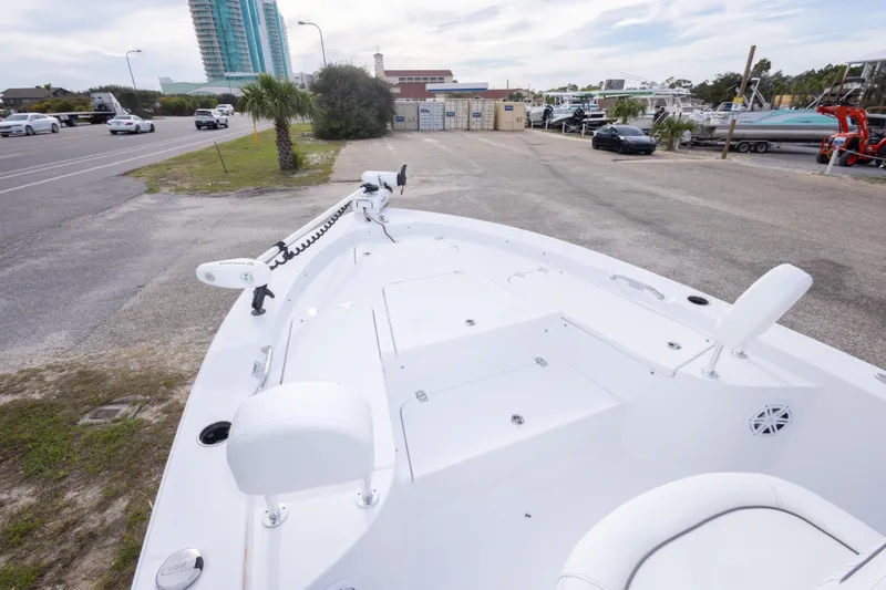 Slide: The Image of 2023 Sportsman Masters 227 Bay Boat parked near a road with buildings in background. - 36