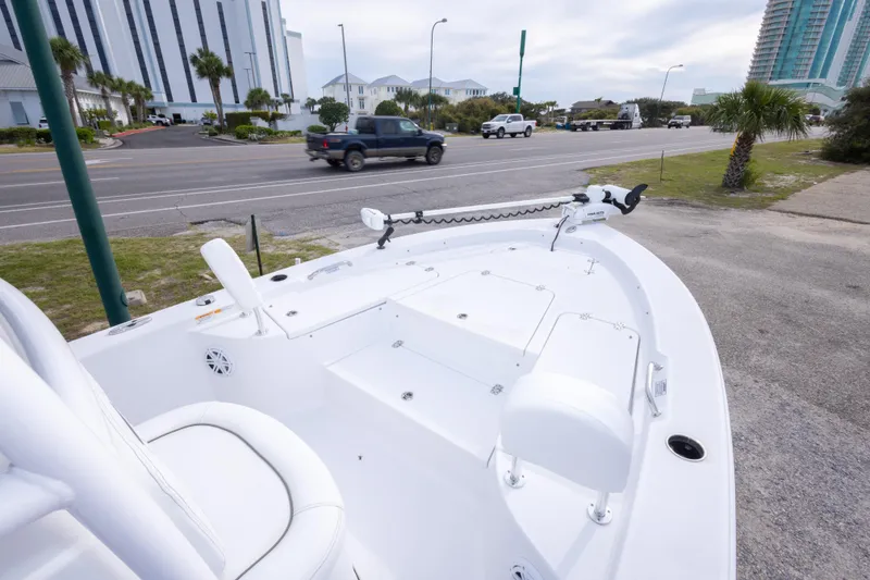 Slide: The Image of 2023 Sportsman Masters 227 Bay Boat parked near a road with buildings in the background. - 37