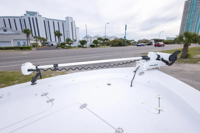 Slide: The Image of 2023 Sportsman Masters 227 Bay Boat with Minn Kota trolling motor, parked near a hotel. - 44