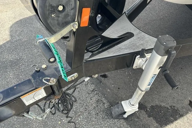Slide: The Image of Trailer hitch and jack of 2018 Malibu Wakesetter 21 VLX on asphalt surface. - 10