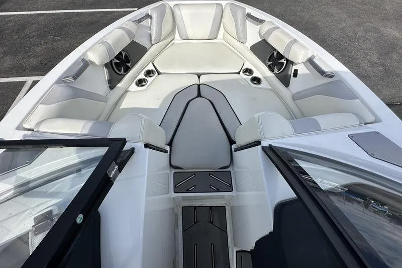 Slide: The Image of 2018 Malibu Wakesetter 21 VLX boat interior with white seating and cup holders. - 15