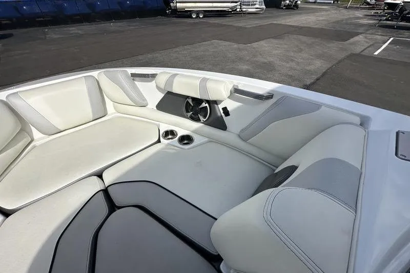 Slide: The Image of 2018 Malibu Wakesetter 21 VLX boat interior with white cushioned seating and cup holders. - 17