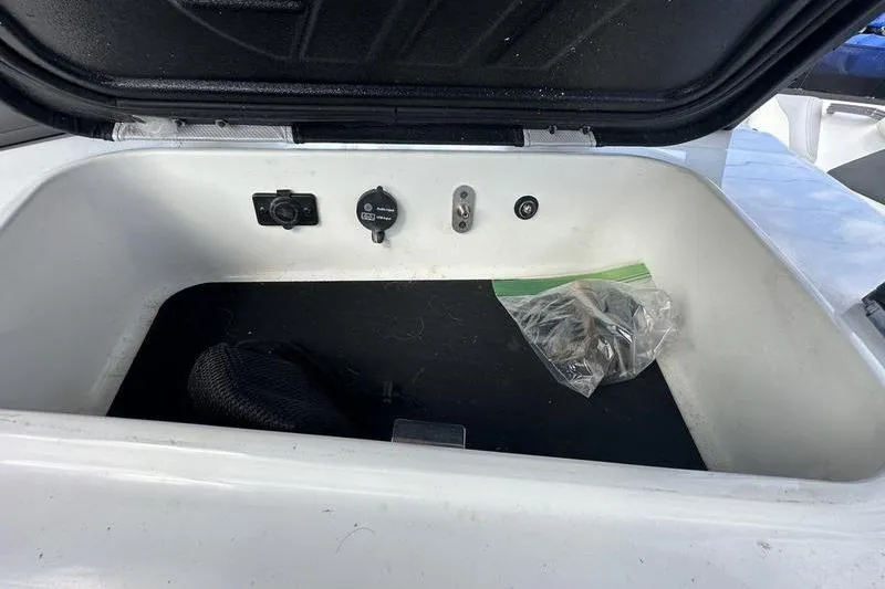 Slide: The Image of Open storage compartment in a 2018 Malibu Wakesetter 21 VLX boat. - 19