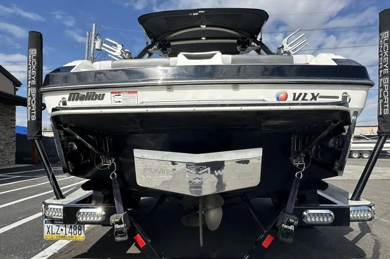 Slide: The Image of 2018 Malibu Wakesetter 21 VLX boat rear view in parking lot. - 2