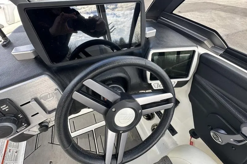 Slide: The Image of 2018 Malibu Wakesetter 21 VLX dashboard with steering wheel and touchscreen controls. - 20
