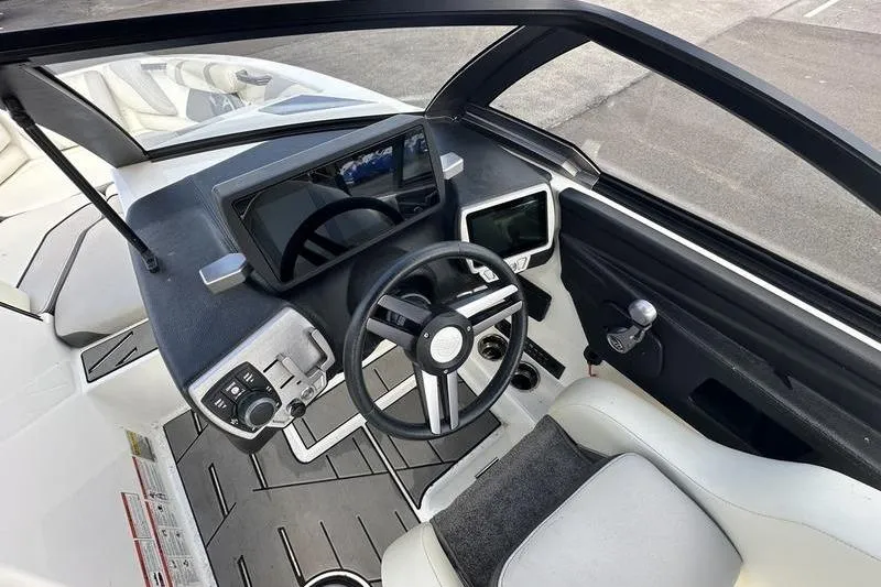 Slide: The Image of 2018 Malibu Wakesetter 21 VLX boat interior with modern dashboard and steering wheel. - 22