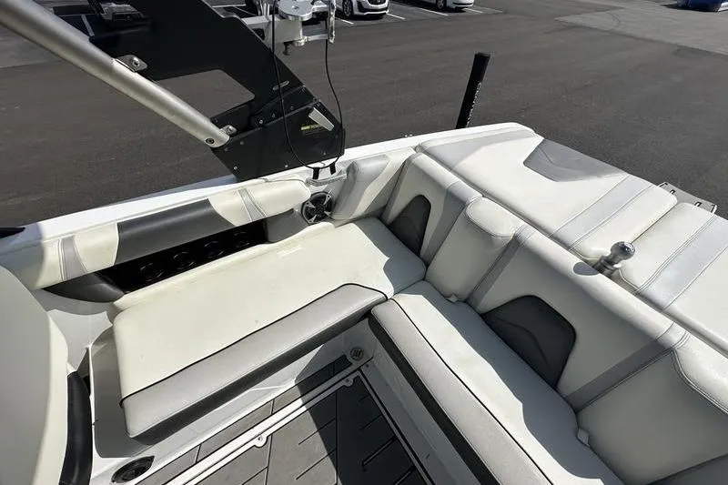 Slide: The Image of 2018 Malibu Wakesetter 21 VLX interior with white and gray seating, showcasing sleek design. - 24