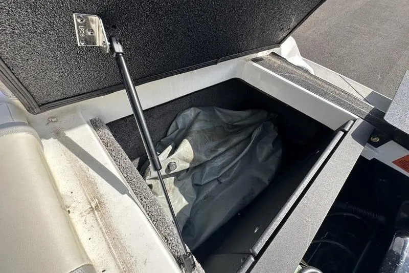 Slide: The Image of Open storage compartment in a 2018 Malibu Wakesetter 21 VLX boat. - 33