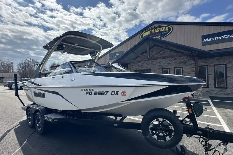 Slide: The Image of 2018 Malibu Wakesetter 21 VLX boat on trailer outside dealership. - 4