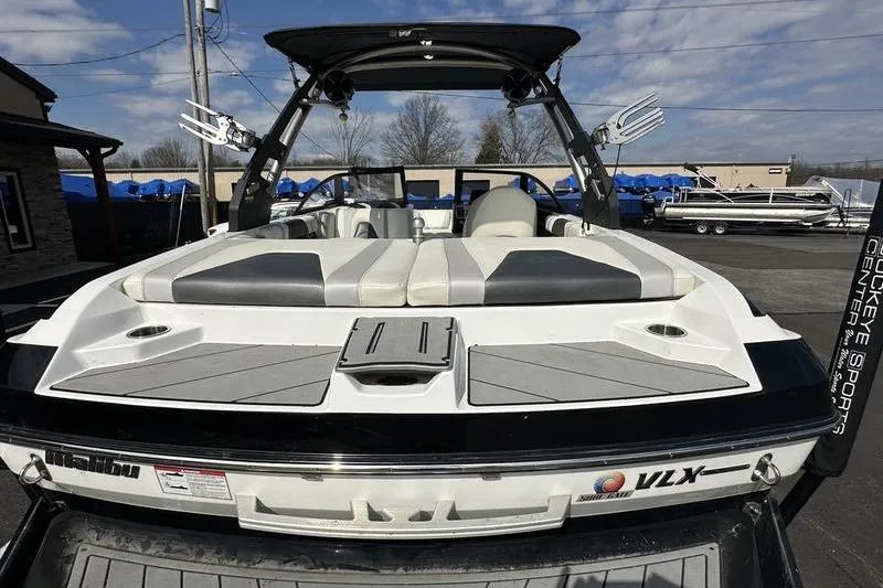 Slide: The Image of 2018 Malibu Wakesetter 21 VLX boat, rear view, showcasing seating and wakeboard tower. - 5