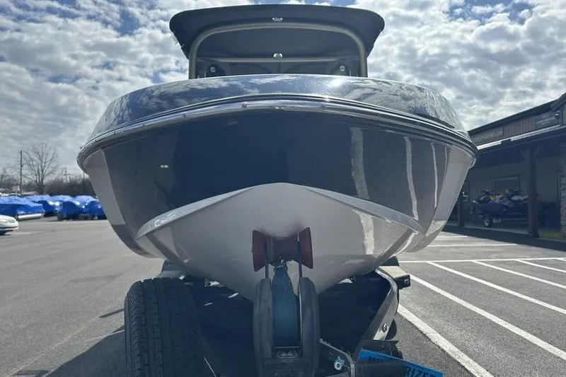 Slide: The Image of 2018 Malibu Wakesetter 21 VLX boat on trailer under cloudy sky. - 8