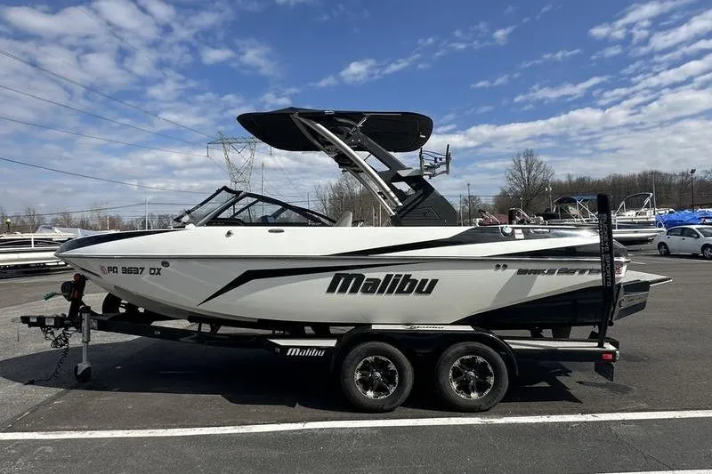 Slide: The Image of 2018 Malibu Wakesetter 21 VLX boat on trailer under blue sky. - 9
