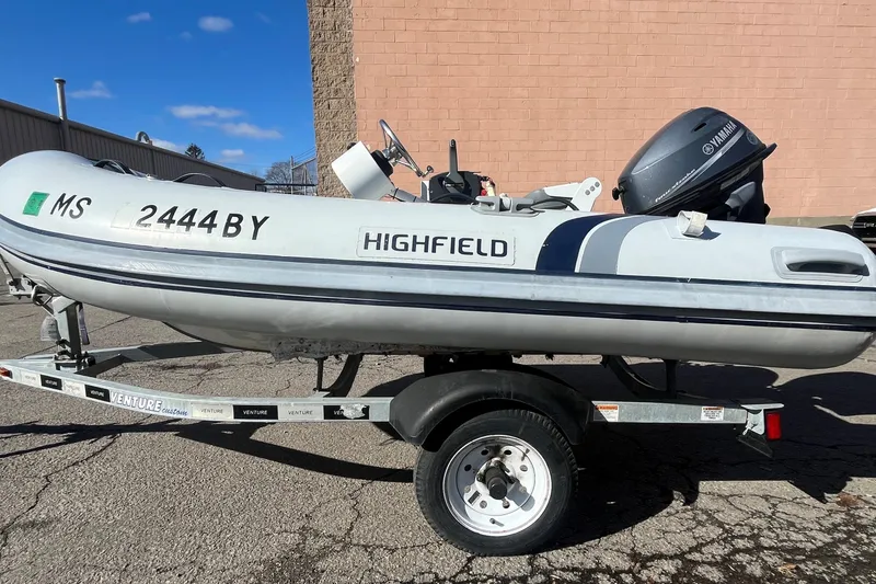 The Image of 2022 Highfield Classic 290 FT inflatable boat on trailer, featuring Yamaha outboard motor. - 0