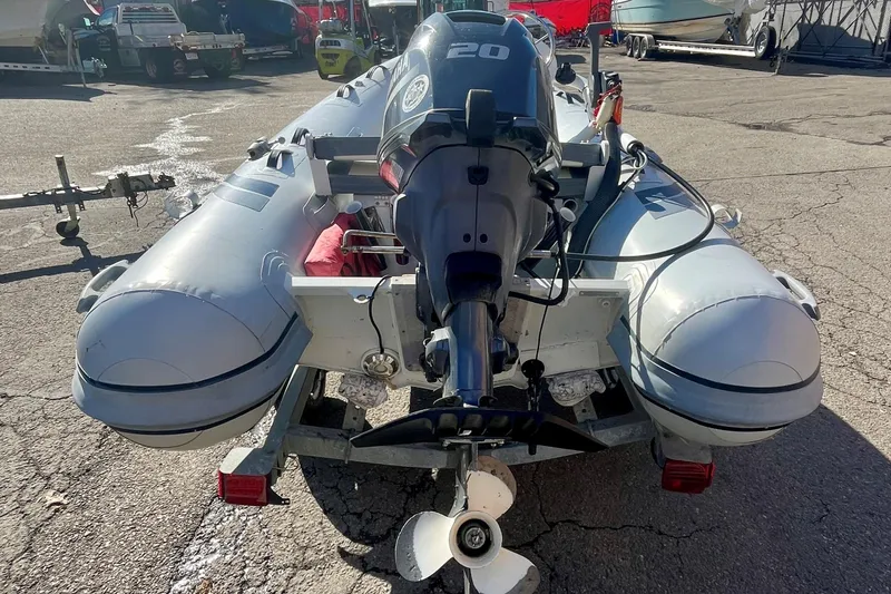 Slide: The Image of 2022 Highfield Classic 290 FT inflatable boat with 20 HP motor on trailer. - 2