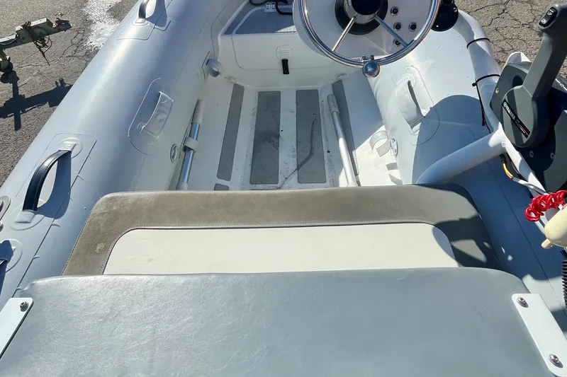 Slide: The Image of 2022 Highfield Classic 290 FT inflatable boat interior with steering wheel and seating. - 4