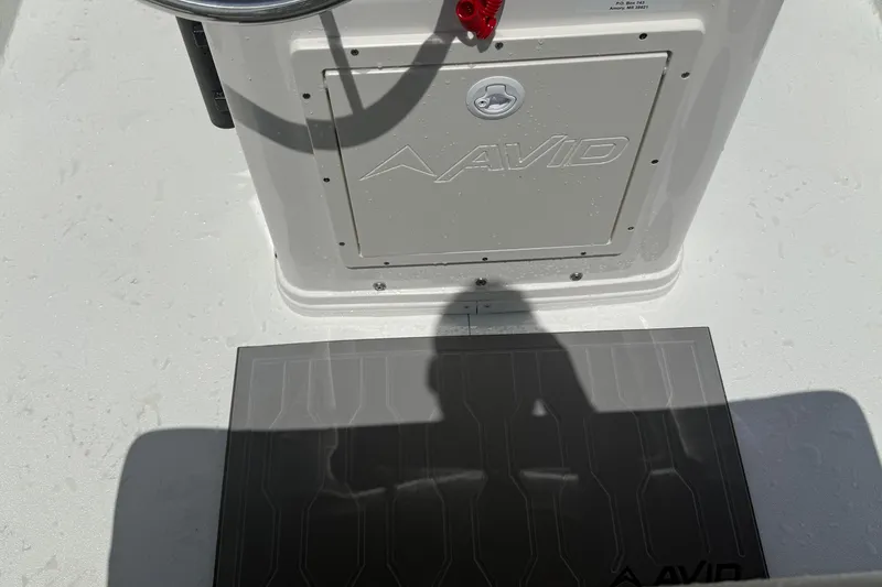 Slide: The Image of 2026 Avid 19 FSX boat console with steering wheel and branded panel. - 11