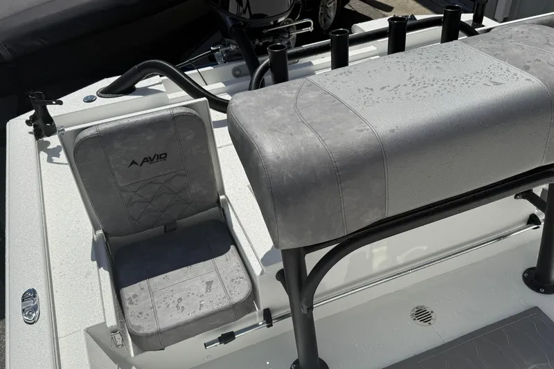 Slide: The Image of Avid 19 FSX 2026 boat interior with gray seating and rod holders. - 15