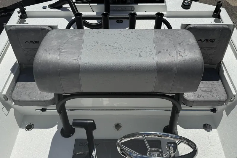 Slide: The Image of 2026 Avid 19 FSX boat interior with gray seating and steering wheel. - 18