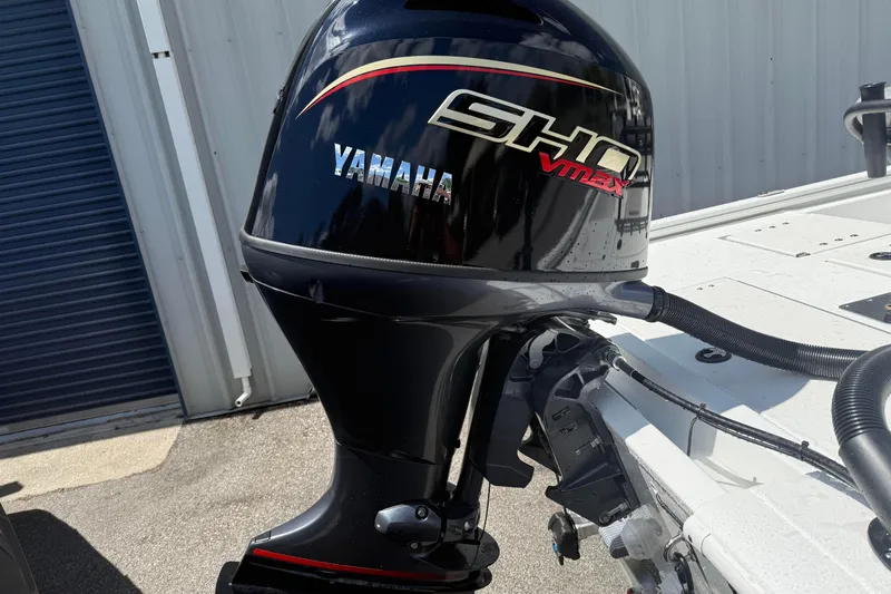 Slide: The Image of Yamaha SHO VMAX outboard motor on 2026 Avid 19 FSX boat, parked outdoors. - 4