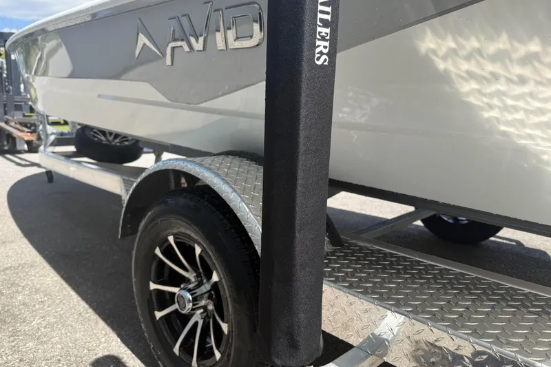 Slide: The Image of 2026 Avid 19 FSX boat on trailer, showcasing sleek design and modern wheels. - 6