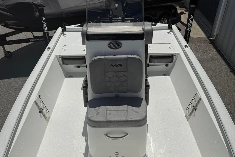 Slide: The Image of 2026 Avid 19 FSX boat interior with central seating and storage compartments. - 9