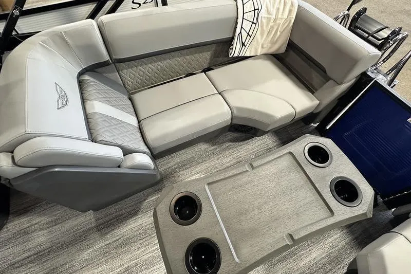 Slide: The Image of Interior of 2026 Bennington 24 M Quad Bench with gray upholstery and table. - 16