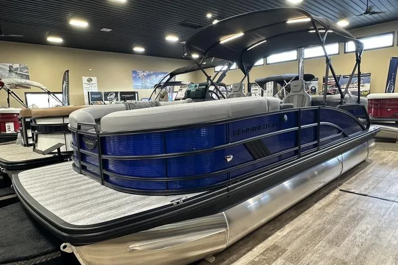 The Image of 2026 Bennington 24 M Quad Bench pontoon boat displayed indoors. - 2
