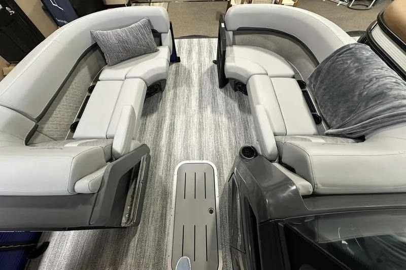 Slide: The Image of 2026 Bennington 24 M Quad Bench interior with gray seating and modern design. - 24