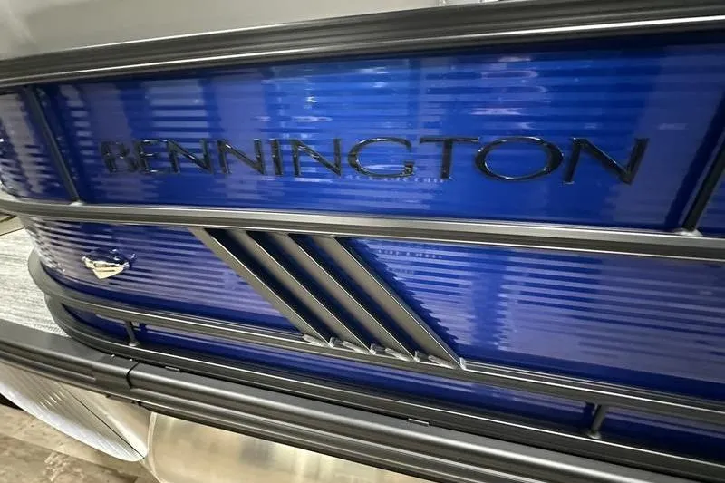 Slide: The Image of 2026 Bennington 24 M Quad Bench pontoon boat with blue paneling and sleek design. - 7