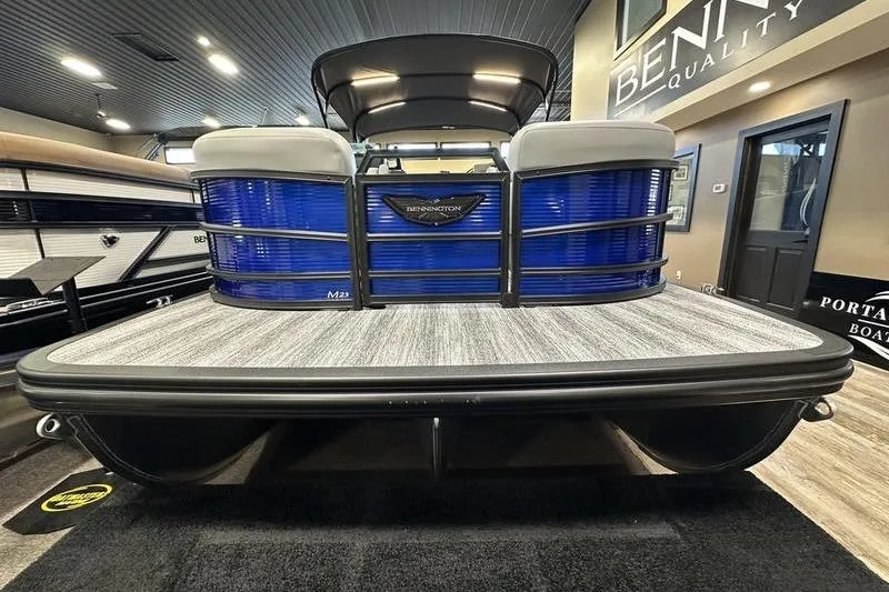 Slide: The Image of 2026 Bennington 24 M Quad Bench pontoon boat displayed indoors. - 9