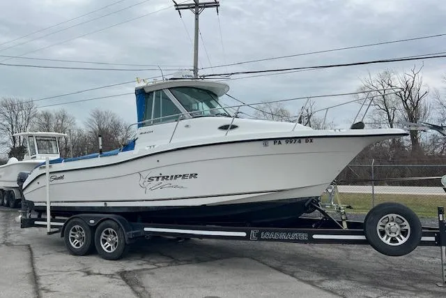 Slide: The Image of 2004 Seaswirl Striper 2601 Walkaround I/O boat on trailer, parked outdoors. - 2