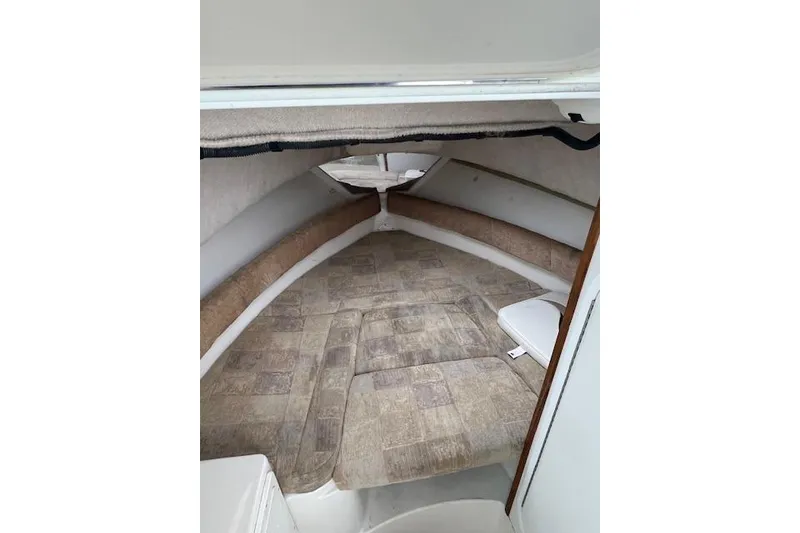 Slide: The Image of 2004 Seaswirl Striper 2601 Walkaround I/O cabin interior with cushioned seating. - 3